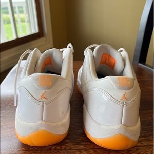 Jordan 11s low orange and white. Slightly worn, like brand new